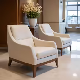 two chairs in a room with mirrors on the walls
