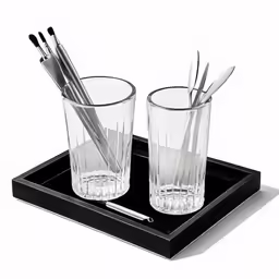 there are two glasses on the tray together