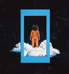 a small orange and black doll in a blue frame