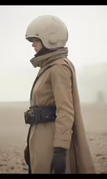 a woman in a trench coat and helmet looks off to the left