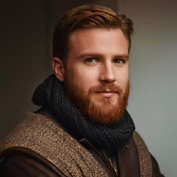 a man with a beard wearing a jacket and a scarf