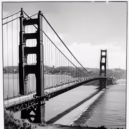 the view of a long suspension bridge that is open to let traffic pass over it