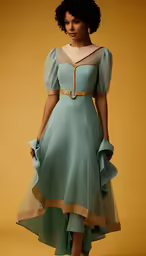 woman in a green frock with golden details