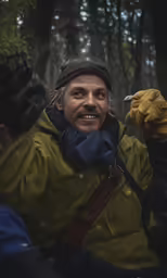 a man smiling as he poses for the camera