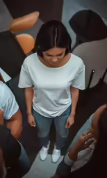 a woman standing in a circle with other people