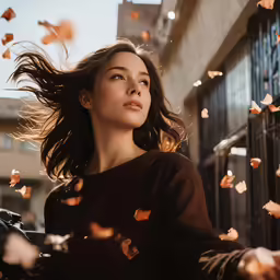 woman staring to the sky with her hair flying around