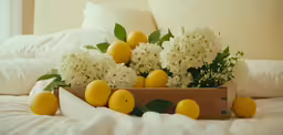 several yellow and white flowers on top of a bed