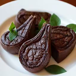 a small group of brownies on a white plate