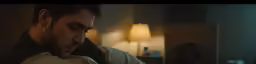 a man looks at his phone in a hotel room