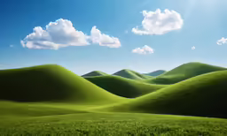 the rolling hills are green with grass on both sides
