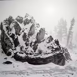 a snowy mountain covered in snow on top of a hill
