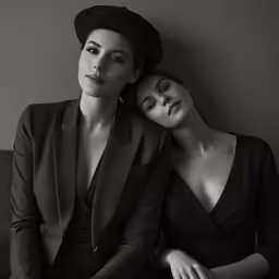 two women sitting together with their faces close