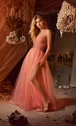 a girl wearing a pink dress poses for the camera