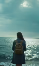 the woman is looking at the water in the sky