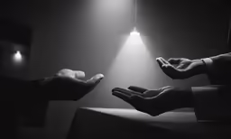 two hands reaching out for a ball of soap