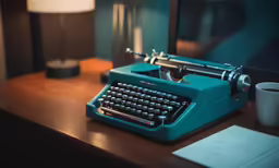 a desk with a typewriter, a paper and a coffee cup