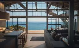 a living room and dining area with ocean view