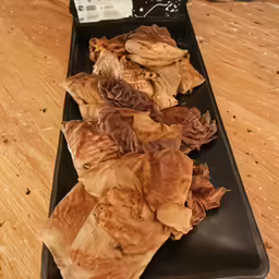 a plate of dumplings on a table with a can