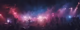people standing in front of a crowd on a stage at night