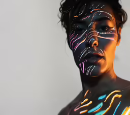 the woman has glowing skin and body art