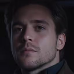 a man in an elegant jacket looking up