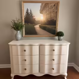 the painting is above the white dresser in the living room