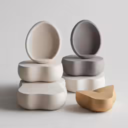 different sized objects and colors sit on a white surface