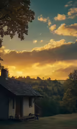 a thatched house on the side of a hill with a tree and mountains in the background