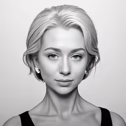 a woman with blonde hair looking into the camera