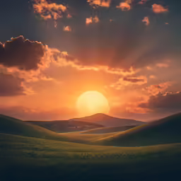 the sun is setting behind the mountains covered with grass