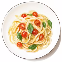 a plate filled with noodles and topped with fresh basil