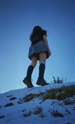 a person is standing in the snow with her back to the camera
