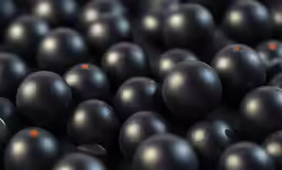 many black balls of varying sizes are grouped together