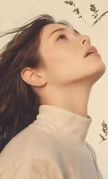 a woman with her hair blowing in the wind