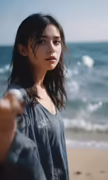 a girl on the beach holding a bat
