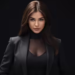 a woman wearing a black dress and jacket