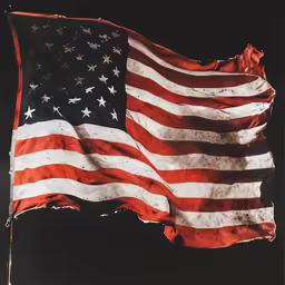 a black background is covered with a large american flag