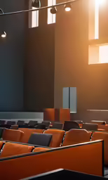 rows of chairs in auditorium with one person standing at the front