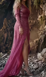 a blonde woman wearing an unusual looking pink gown posing for a photo