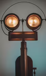 a close up of a street light on a blue wall