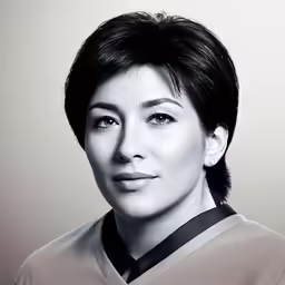 a woman with short dark hair and an asian style blouse