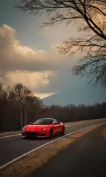 a red car driving down the road near a tree