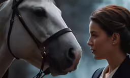 an image of a woman kissing a horse