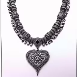 a necklace with heart charms is in the picture,an elaborate necklace is attached to a white background