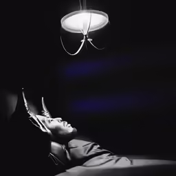 black and white photo of man in the dark