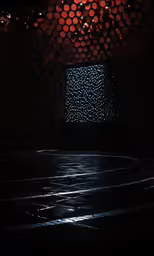 a man skateboarding on wet concrete in a dark room