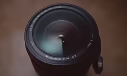 a camera lens is sitting next to an object
