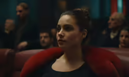 the woman in black is looking away from the audience