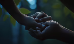 two hands holding each other above their fingers