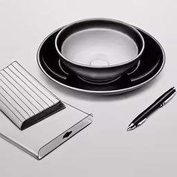 a plate and notebook next to a pen